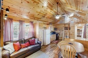 a living room with a couch and a table in a cabin at Meandering Moose Cabin in Florissant