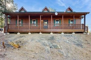a large log cabin with a large deck at Meandering Moose Cabin in Florissant