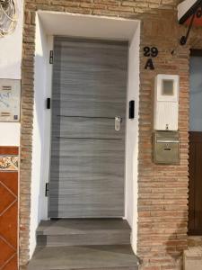 a metal garage door in a brick wall at Suites Prieto Fuengirola Centro in Fuengirola