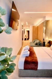 a hotel room with a bed with towels on it at Miriam by Dozzze in Madrid +53 photos