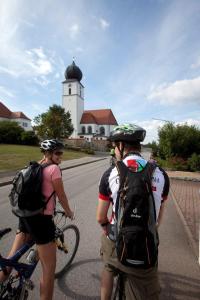 a group of people riding bikes down a street at Kuschelige Ferienwohnung in Schwandorf in Bayern