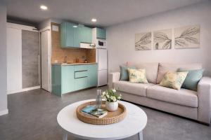 a living room with a couch and a table at Suites Prieto Fuengirola Centro in Fuengirola