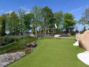 a miniature golf course with a bridge over a river at Himmerland Stay, Golf & Spa in Farsø