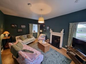 a living room with two couches and a fireplace at Midhope Castle Cottages in Queensferry +24 photos