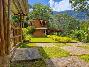 a house with a pathway leading to the front of it at Cabaña Campestre de Descanso in Melgar