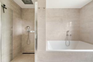 a bathroom with a bath tub and a shower at Luxury Apartment Marz in Schwanau +47 photos
