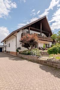 a white building with a tree in front of it at Luxury Apartment Marz in Schwanau
