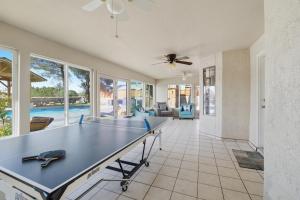 a living room with a ping pong table in it at Private Beach Volleyball Pool Retreat in Las Cruces