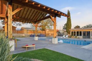 a large wooden pavilion with a pool in a backyard at Private Beach Volleyball Pool Retreat in Las Cruces