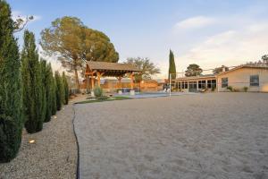 a large driveway with a gazebo in front of a building at Private Beach Volleyball Pool Retreat in Las Cruces