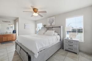 a bedroom with a bed and a ceiling fan at Private Beach Volleyball Pool Retreat in Las Cruces +64 photos