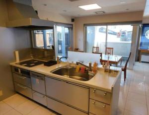 a kitchen with a sink and a counter top at Takayama Fortune-inn in Takayama