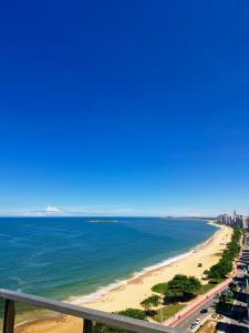a view of the beach from a balcony at Praia Dourada SUÍTE ITAPARICA 1206 in Vila Velha