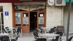 a group of tables and chairs outside of a restaurant at Hostal Ribeiro Verín in Verín