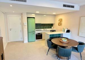 a kitchen with a table and chairs in a room at Palm Forest Oasis in Mijas Costa