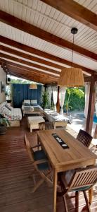 a living room with a wooden table and chairs at Villa CYNNE Paradis Tropical in Baie-Mahault