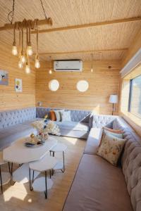 a living room with a couch and a table at اكواخ الغصن الريفيه in Jeddah +25 photos