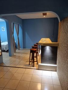 a kitchen with a table and stools in a room at Casa Maya Vibes in Santiago Atitlán