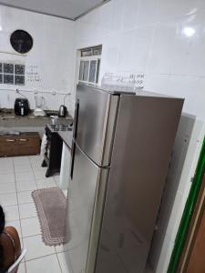 a stainless steel refrigerator in a kitchen with writing on it at Hostel Espaço Mulher in Florianópolis +10 photos