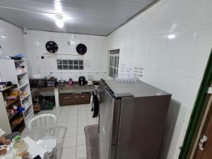 a kitchen with a stainless steel refrigerator in it at Hostel Espaço Mulher in Florianópolis