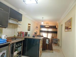 a kitchen with a counter top and a living room at العين السخنة palm beach resort شاليه عائلات فقط in Ain Sokhna