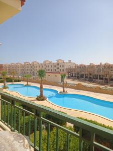 a view of a pool from the balcony of a apartment at العين السخنة palm beach resort شاليه عائلات فقط in Ain Sokhna