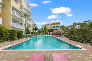 a swimming pool in front of a building at Blue Bay Apartments in Dorp Sint Michiel