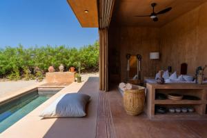 a villa with a swimming pool and a patio at Mazul Puerto Escondido in Tlachicón