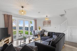 a living room with a couch and a tv at 3 Bed in Brynteg oc-d33659 in Brynteg