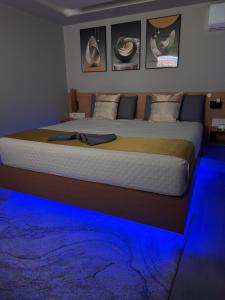 a bedroom with a bed with blue lights on it at N3XT LEVEL home in Praia
