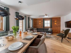 a dining room and living room with a table and chairs at Alpenjoy Lodge in Donnersbachwald