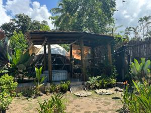a gazebo with a tent in a garden at Bambuk Bio Dome Uvita beach front in Uvita
