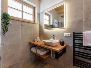 a bathroom with a sink and a mirror at Alpenjoy Lodge in Donnersbachwald +51 photos