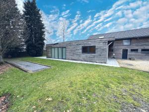 a house with a grass yard in front of it at Annexe in Sourbrodt