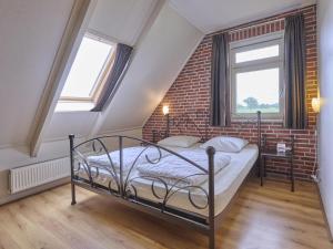 a bedroom with a bed and a brick wall at t Achterhoes in Neede