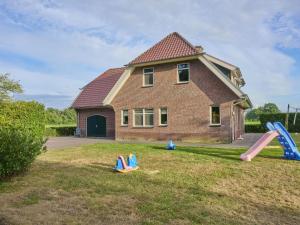 a house with playground equipment in the yard at t Achterhoes in Neede
