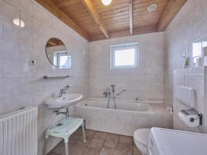 a bathroom with a tub and a sink and a toilet at Erve Koeleman in Neede +60 photos