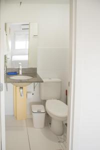 a white bathroom with a toilet and a sink at Areatricolor in Porto Alegre +57 photos