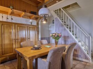 a dining room with a wooden table and chairs at Erve Koeleman in Neede