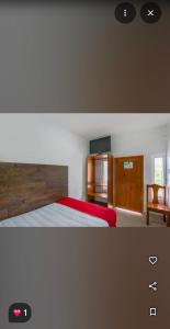 a bedroom with a bed with a red bedspread and a cabinet at Hotel Palma Real in Francisco Uh May