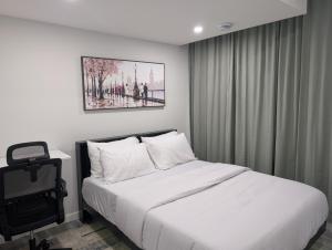 a bedroom with a bed and a picture on the wall at Calgary Serene Suite - 19mins from airport, 1hr to Banff, 85" Cinema, Fibre WiFi, Full Kitchen in Calgary