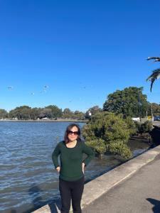 a woman standing next to a body of water at 海边度假屋 in Sydney