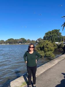 a woman standing next to a body of water at 海边度假屋 in Sydney +2 photos