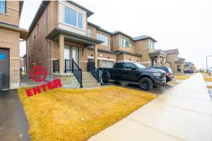 a truck parked in a yard in front of a house at Caledon Quiet Luxury Escape 3BR Suite in Brampton