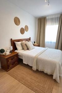 a bedroom with a large bed and a window at CASA DEL MAR-Costa Daurada in Cunit