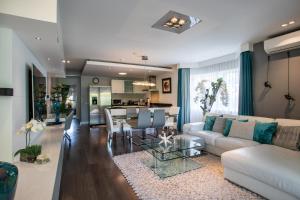 a living room with a couch and a table at Blue Bay Apartments in Dorp Sint Michiel