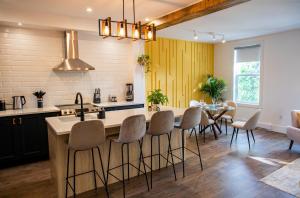 a kitchen with a island and a table with chairs at Halifax's Most Popular Historic Modern Space in Halifax
