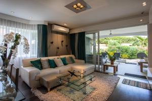 a living room with a couch and a table at Blue Bay Apartments in Dorp Sint Michiel +205 photos