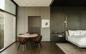 a bedroom with a bed and a table and chairs at Alexander, Member of The Leading Hotels of the World in Mexico City