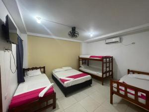 a room with two beds and a tv in it at AMAREA Hotel Boutique in Tolú